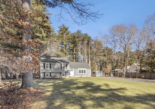 exterior space with fence and a lawn