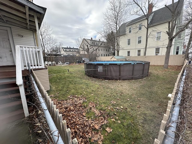 view of yard with a fenced in pool