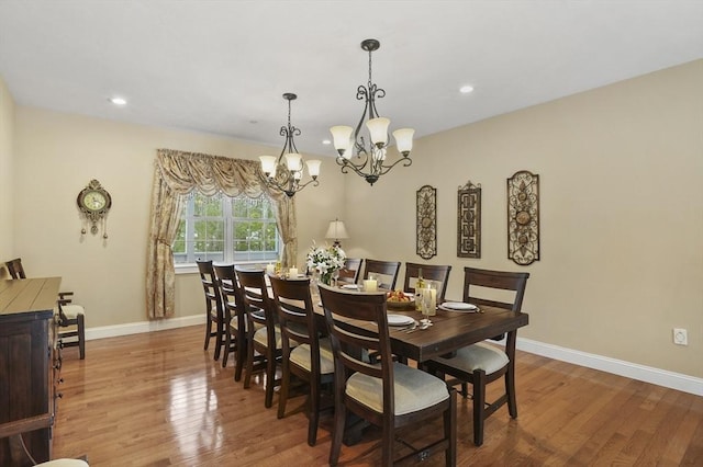 dining room with recessed lighting, an inviting chandelier, wood finished floors, and baseboards