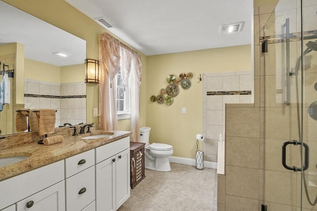 full bath with double vanity, a stall shower, a sink, and visible vents