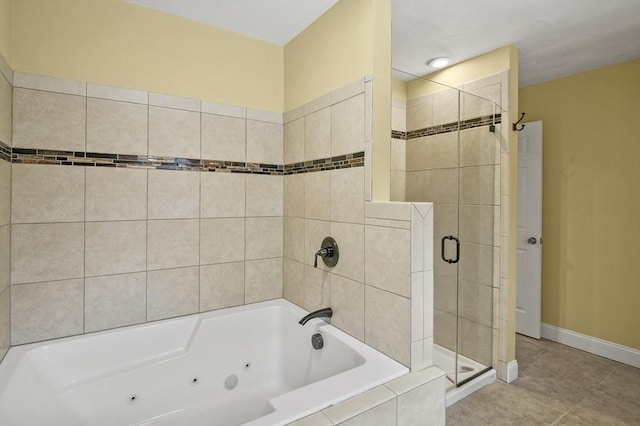 full bath featuring a stall shower, tile patterned flooring, a jetted tub, and baseboards