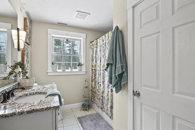 full bath featuring visible vents, toilet, vanity, baseboards, and tile patterned floors