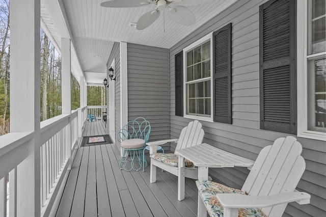 deck with ceiling fan and a porch