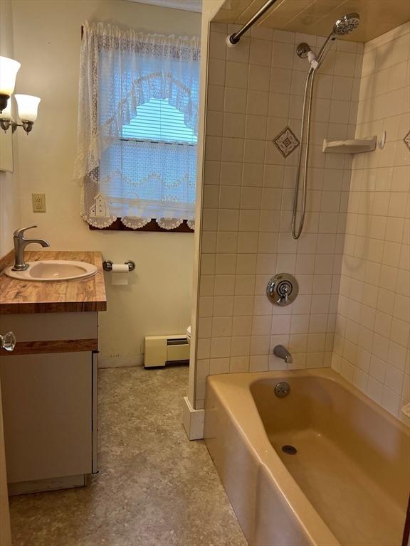 318 Holden St, Holden, MA 01520 - full bath with baseboard heating, vanity, bathing tub / shower combination, and baseboards