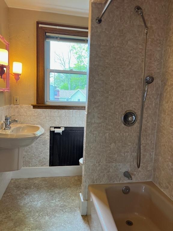 318 Holden St, Holden, MA 01520 - bathroom with shower / bathtub combination, a fireplace, and crown molding