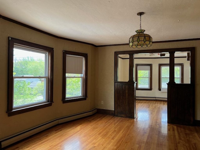 318 Holden St, Holden, MA 01520 - empty room featuring a baseboard radiator, plenty of natural light, light wood-style floors, ornamental molding, and a textured ceiling
