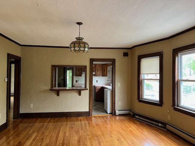 318 Holden St, Holden, MA 01520 - spare room with a baseboard heating unit, light wood-style flooring, ornamental molding, a textured ceiling, and baseboards