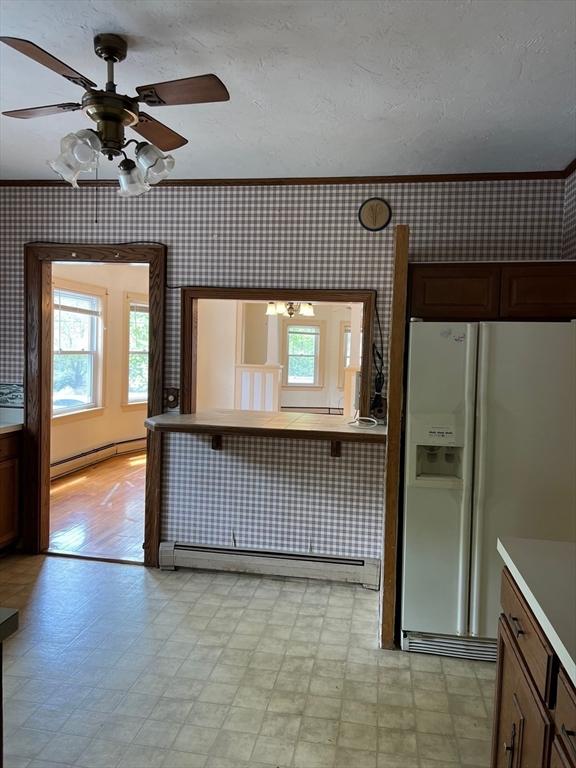 318 Holden St, Holden, MA 01520 - kitchen featuring white fridge with ice dispenser, wallpapered walls, a baseboard radiator, baseboard heating, and light flooring