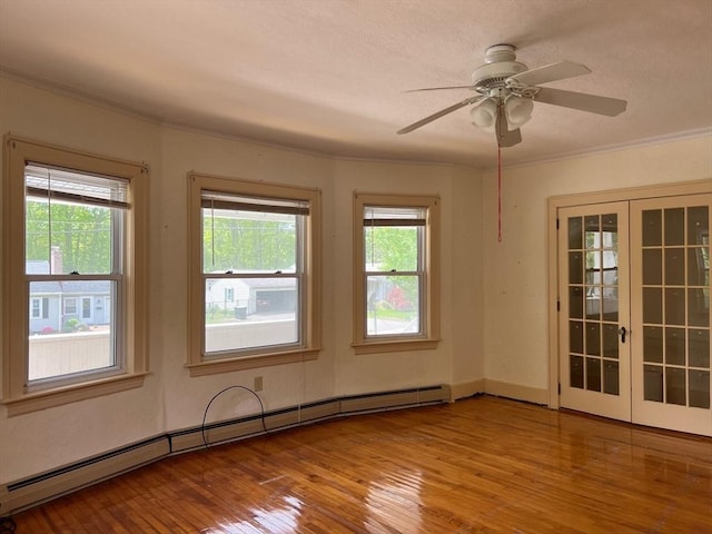318 Holden St, Holden, MA 01520 - spare room with a baseboard radiator, wood finished floors, a ceiling fan, and crown molding