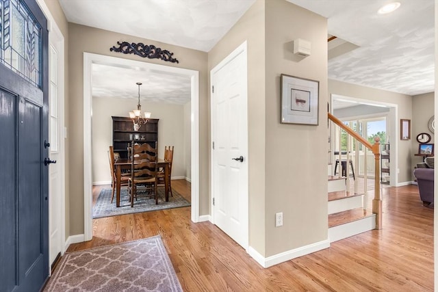 67 Hillside St, Rowley, MA 01969 - entryway with stairs, wood finished floors, baseboards, and a chandelier