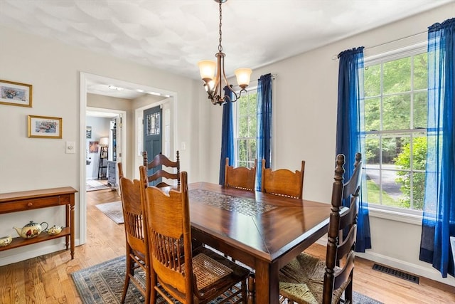 67 Hillside St, Rowley, MA 01969 - dining area featuring a chandelier, plenty of natural light, and light wood-style floors