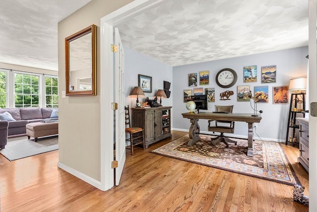 67 Hillside St, Rowley, MA 01969 - home office featuring light wood-type flooring, baseboards, and a textured ceiling