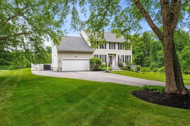 67 Hillside St, Rowley, MA 01969 - colonial inspired home with asphalt driveway, an attached garage, a front lawn, and a shingled roof