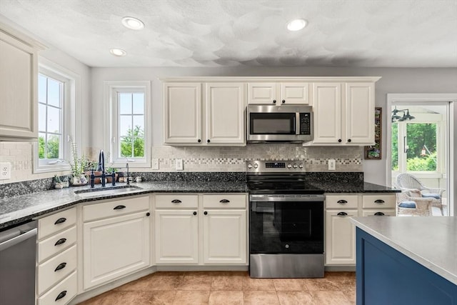 67 Hillside St, Rowley, MA 01969 - kitchen with appliances with stainless steel finishes, a sink, plenty of natural light, tasteful backsplash, and recessed lighting