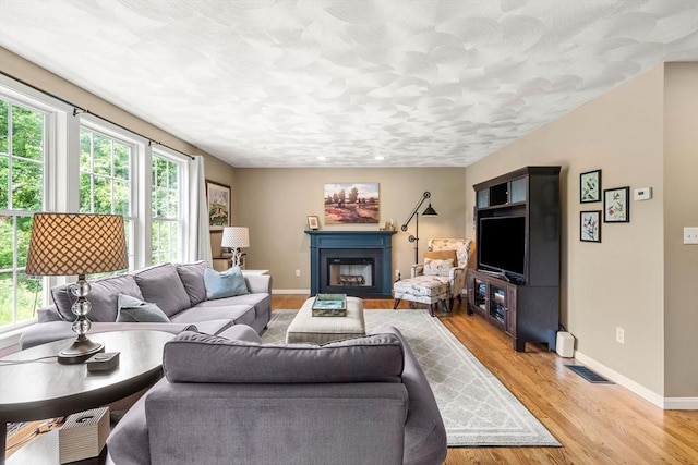 67 Hillside St, Rowley, MA 01969 - living room featuring plenty of natural light, baseboards, and light wood-style floors