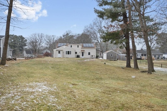 exterior space with a yard and solar panels