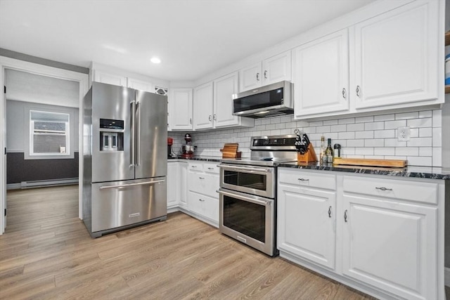 kitchen with light hardwood / wood-style flooring, tasteful backsplash, a baseboard heating unit, white cabinetry, and appliances with stainless steel finishes