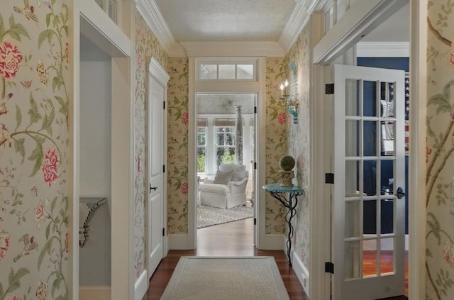 doorway to outside with ornamental molding, dark wood-style floors, and wallpapered walls