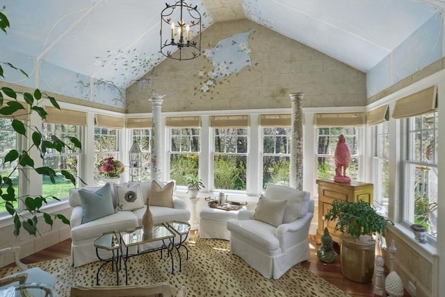 sunroom / solarium with high vaulted ceiling and wood finished floors