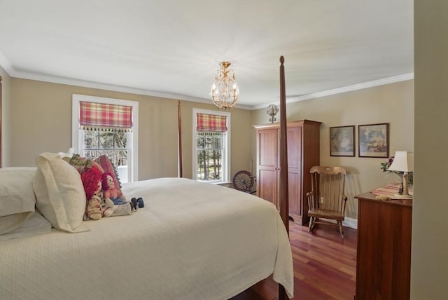 bedroom featuring baseboards, ornamental molding, dark wood-type flooring, and a notable chandelier