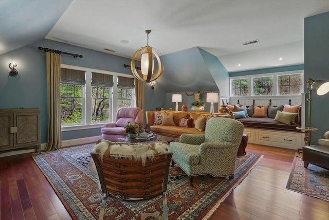 living area featuring vaulted ceiling, hardwood / wood-style flooring, and visible vents