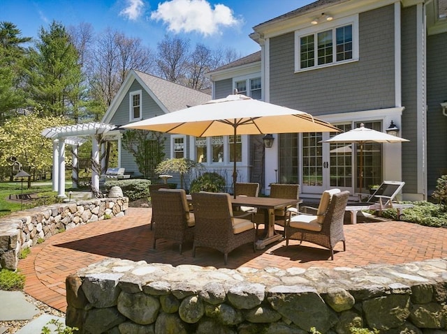 view of patio featuring a pergola and outdoor dining space