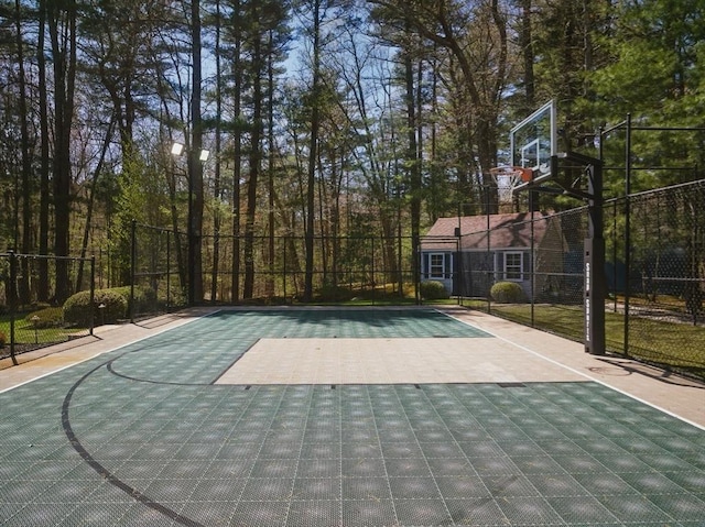 view of sport court with basketball court and fence