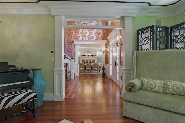interior space featuring wood-type flooring, decorative columns, and ornamental molding