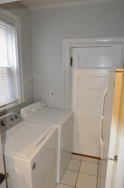 washroom with washing machine and dryer, laundry area, and light tile patterned floors