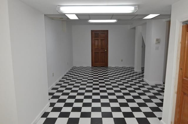 spare room with baseboards and tile patterned floors