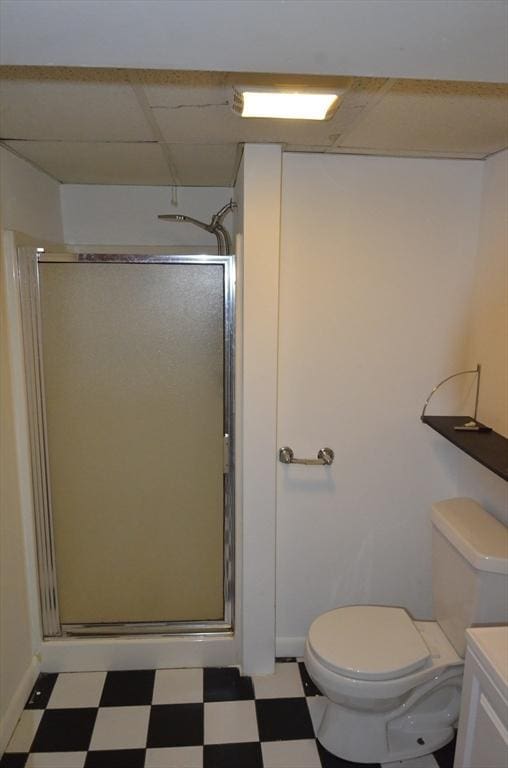 full bathroom featuring toilet, a shower stall, and tile patterned floors