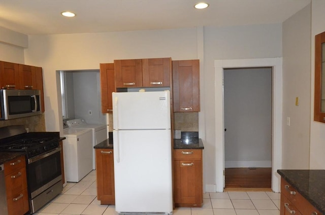 kitchen featuring light tile patterned floors, tasteful backsplash, recessed lighting, appliances with stainless steel finishes, and washing machine and dryer