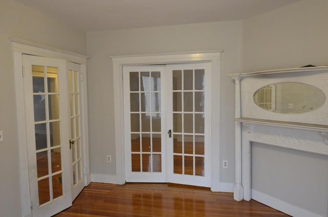 doorway featuring french doors, wood finished floors, and baseboards