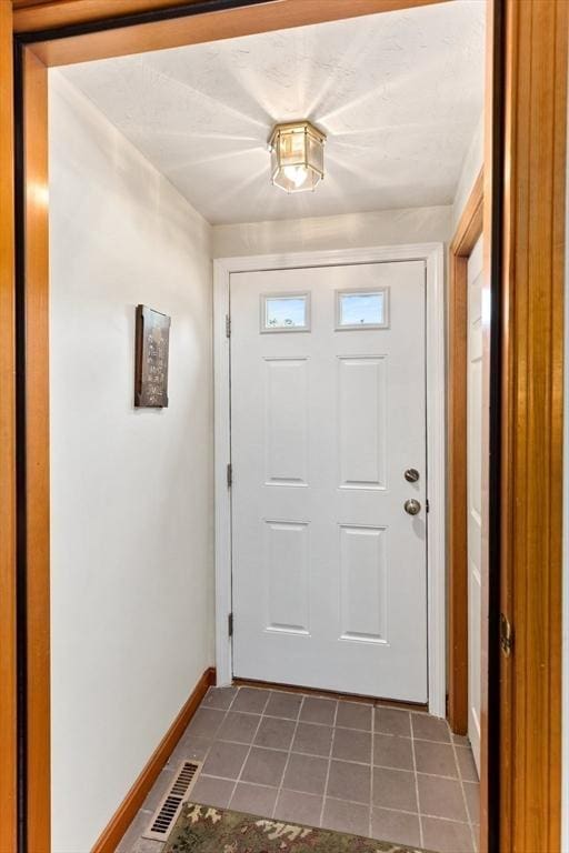 23 Indian Cove Way Unit 23, Easton, MA 02375 - doorway with baseboards and tile patterned flooring