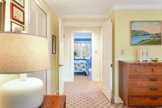 hallway featuring light colored carpet and ornamental molding