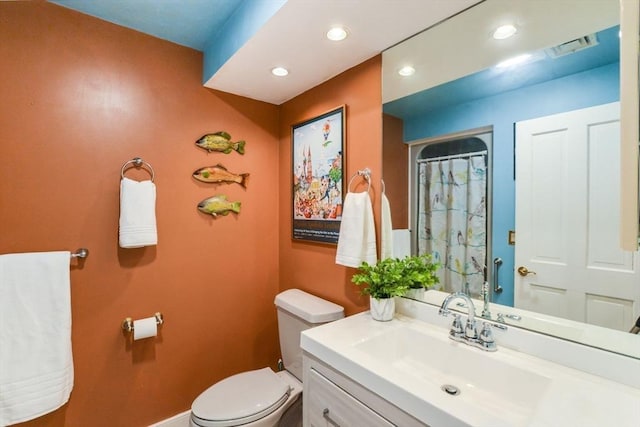 bathroom with a shower with curtain, vanity, and toilet