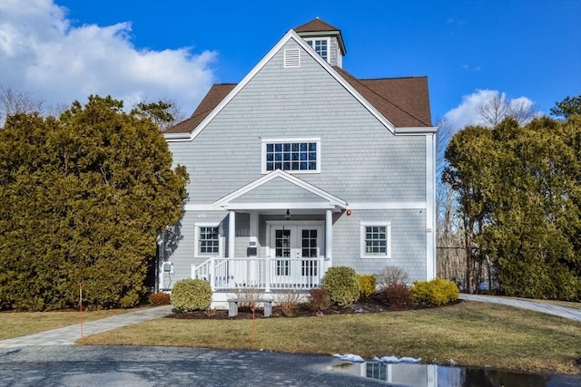 view of front of property featuring a front lawn and french doors