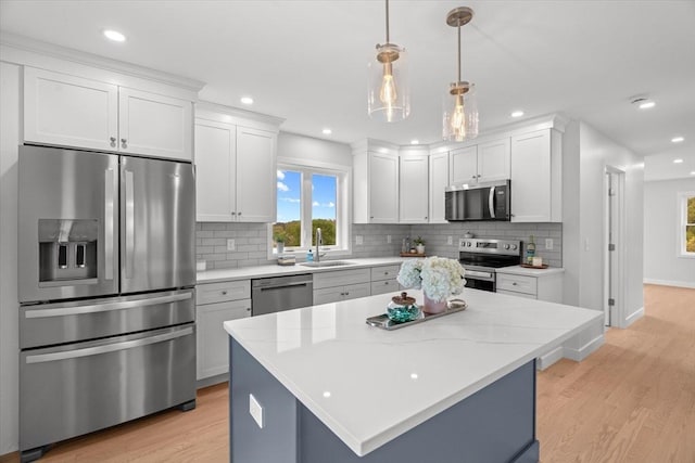 kitchen with stainless steel appliances, light wood-type flooring, a sink, plenty of natural light, and recessed lighting