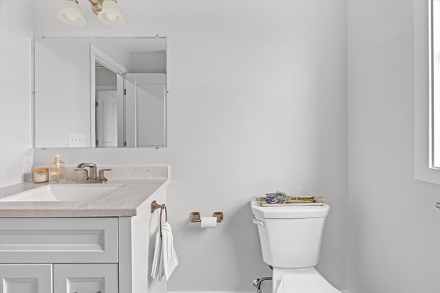 half bathroom featuring toilet and vanity