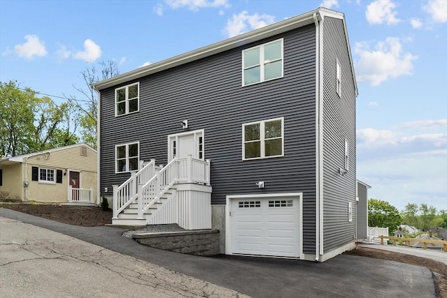 view of front of house featuring a garage and asphalt driveway