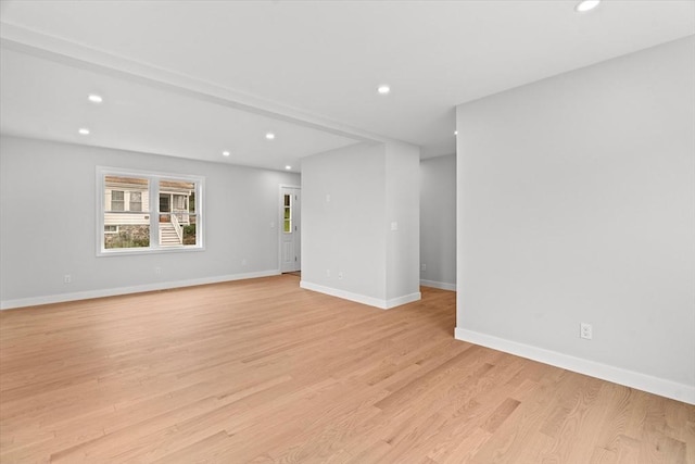 below grade area with recessed lighting, light wood-style floors, and baseboards