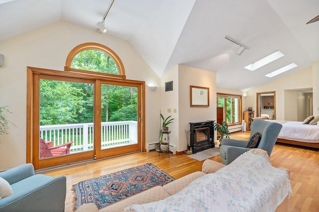 5 Whipple Rd, Hamilton, MA 01982 - living area with track lighting, vaulted ceiling, a skylight, plenty of natural light, and a baseboard radiator