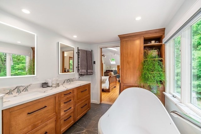 5 Whipple Rd, Hamilton, MA 01982 - ensuite bathroom featuring a freestanding bath, double vanity, marble finish flooring, and recessed lighting