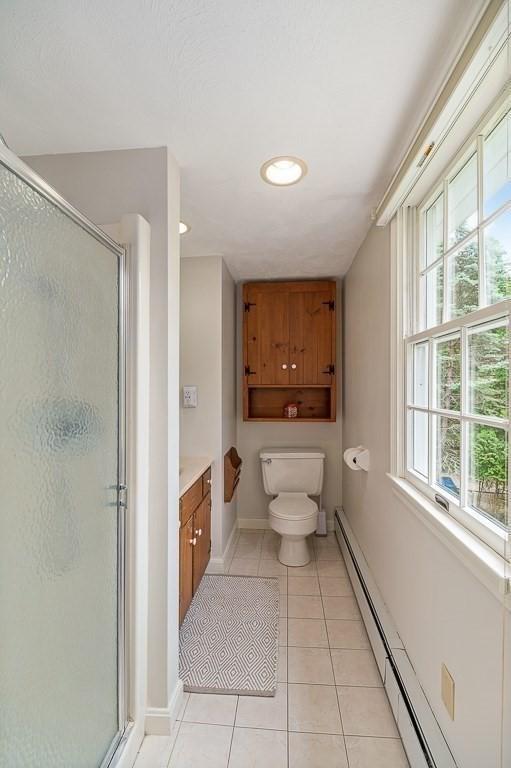 5 Whipple Rd, Hamilton, MA 01982 - full bath with tile patterned flooring, a stall shower, vanity, a baseboard heating unit, and recessed lighting