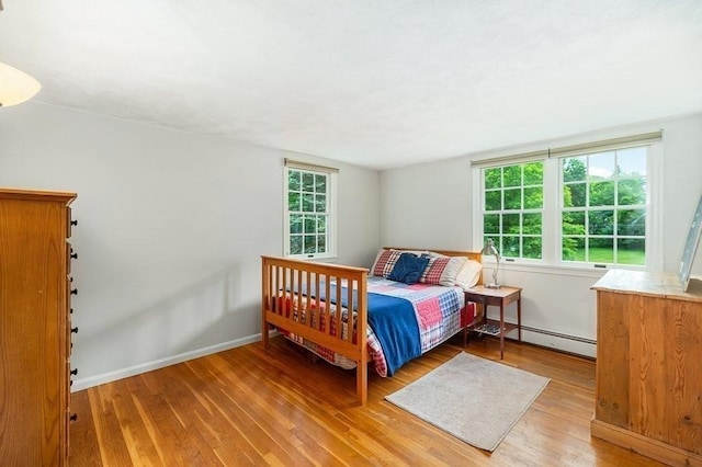 5 Whipple Rd, Hamilton, MA 01982 - bedroom featuring a baseboard radiator, wood finished floors, and multiple windows