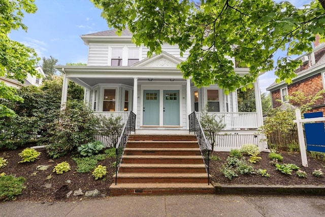 american foursquare style home with a porch