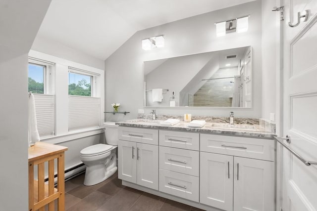 bathroom with a baseboard radiator, vaulted ceiling, toilet, a walk in shower, and double vanity