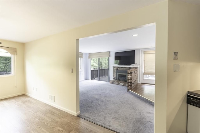 73 Mountain Gate Rd Unit 73, Ashland, MA 01721 - unfurnished living room with a brick fireplace, wood finished floors, baseboards, and recessed lighting