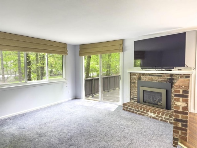 73 Mountain Gate Rd Unit 73, Ashland, MA 01721 - unfurnished living room with a brick fireplace, baseboards, and carpet