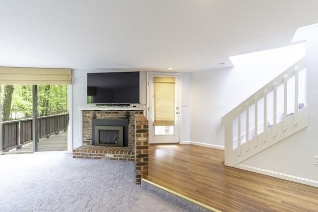 73 Mountain Gate Rd Unit 73, Ashland, MA 01721 - living room with baseboards, a brick fireplace, wood finished floors, stairs, and recessed lighting